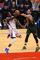 Clippers' forward Luc Mbah a Moute shoots over Jazz forward Gordon Hayward in Los Angeles
