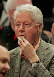 Former US President Bill Clinton attends the Cincinnati vs Syracuse semi-final game at the NCAA Big East Men's Basketball Championships in New York