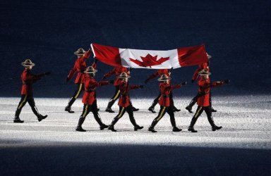 Canadian Mounties carry in the Canadian Flag at the opening ceremony for the 2010 Winter Olympics
