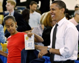 President Obama and First Lady Michelle Obama pack care packages from Military families in Washington