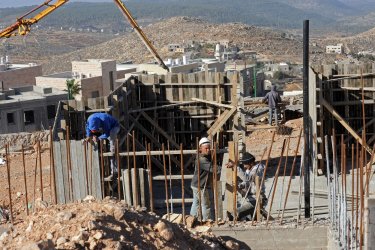 Palestinian laborers build new Jewish housing in the Israeli settlement Har Gilo in the West Bank