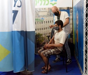 An Israeli Receives A Booster COVID-19 Vaccination In Jerusalem