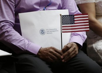 A man waves an American Flag at U.S. naturalization ceremony