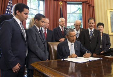 President Obama signs the "Rafael Ramos and Wenjian Liu National Blue Alert Act of 2015" in Washington