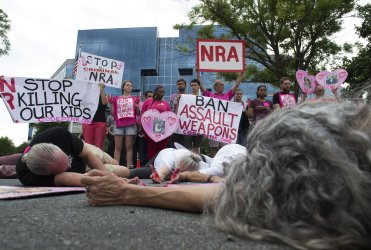 Protesters conduct a die-in at the NRA headquarters