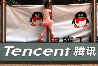 A young girl plays outside Tencent's headquarters in Shenzhen