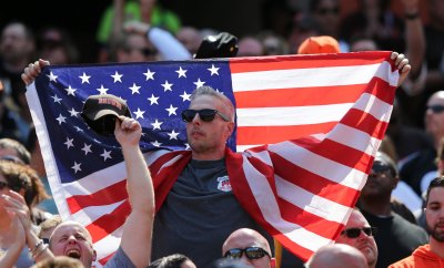 A Cleveland Browns fan hold a American flag during a salute to the armed forces during game against the Steelers