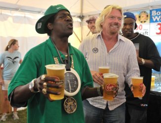 Sir Richard Branson serves beer with Flava Flav at the Virgin Mobil Freefest in Maryland