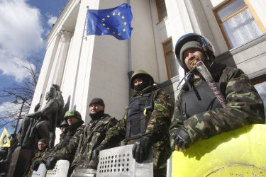 Ukrainian self defense volunteers stand outside the parliament building in Kiev