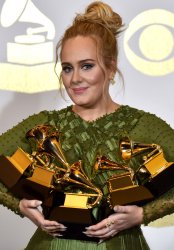 Adele wins an award at the 59th annual Grammy Awards in Los Angeles