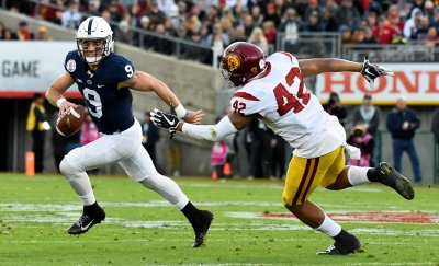 Penn State quarterback Trace McSorley scrambles to avoid the tackle of USC Trojans' Uchenna Nwosu