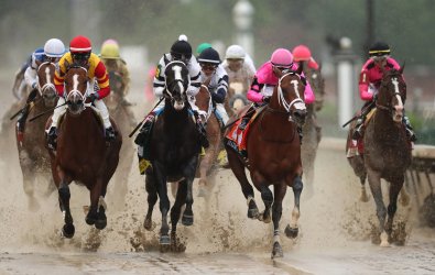 Horses race down to the first turn in the 145th Kentucky Derby