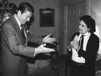 President Ronald Reagan greets UPI White House reporter Helen Thomas