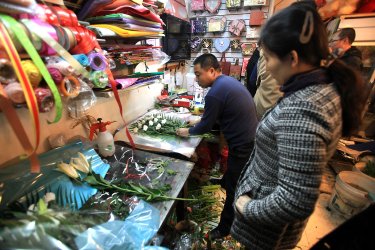 North Koreans buy flowers to take to the North Korean embassy in Beijing