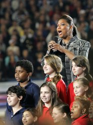 Queen Latifah sings God Bless America prior to kickoff for Super Bowl XLIV in Miami