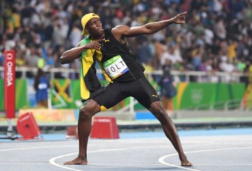 Jamaican gold medalist Usain Bolt strikes a pose after the Men's 100M Final at the 2016 Rio Summer Olympics