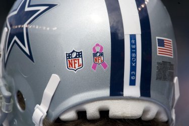 Cowboys Guard Kosier Wears Pink Ribbon on Helment in Denver