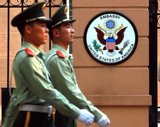 Chinese soldiers march past part of the United States Embassy in Beijing