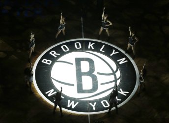 The Brooklynettes dancers perform on the court