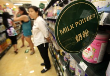 Chinese women shop for dried milk products in Beijing