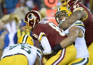 Redskins quarterback Kirk Cousins is sacked for a loss