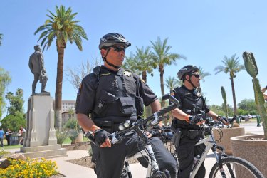 Deputies watch crowd reacting to US Supreme Court's decision on SB1070 in Arizona