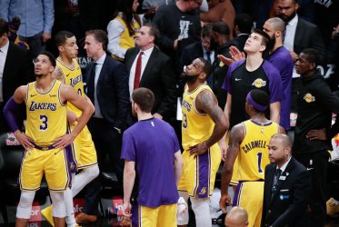 Lakers LeBron James and team stand near the bench