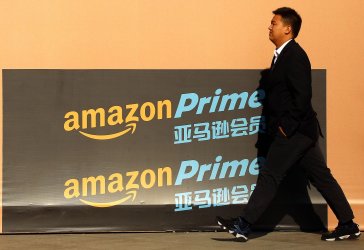 A Chinese man walks past a newly-opened Amazon Prime showroom in Beijing