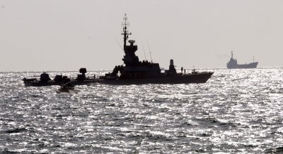 The seized Rachel Corrie ship is escorted by Israeli navy vessels in the Ashdod military port