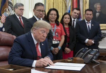 United States President Donald J. Trump signs an Executive Order Establishing the Task Force 