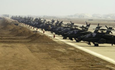 APACHE HELICOPTERS LINE AN AIRFIELD