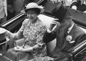 Queen Elizabeth II and Prince Philip arive at the Royal Ascot in an open carriage