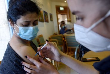 A Caregiver Receives A COVID-19 Vaccine In The Migdal Nofim Assisted Living Facility In Jerusalem
