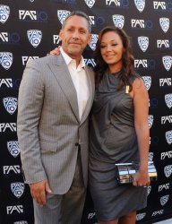 Angelo Pagan and Leah Remini attend FOX Sports/PAC-10 Conference Hollywood premiere night in Los Angeles
