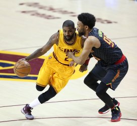Cleveland Cavaliers' Kyrie Irving drives to the basket while defended by Atlanta Hawks' DeAndre' Bembry
