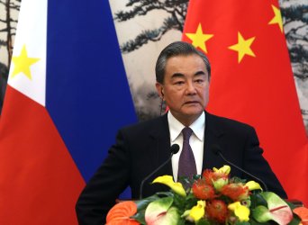 Wang listens to a question at a press conference in Beijing, China