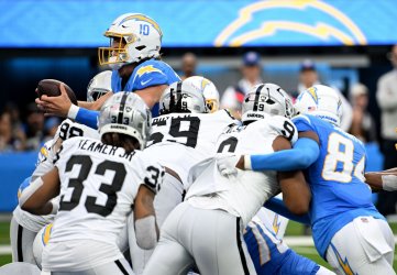 Chargers Herbert Dives Into the End Zone Against the Raiders at SoFi Stadium