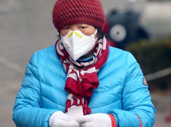 A Chinese woman wears a protective face mask in Beijing, China