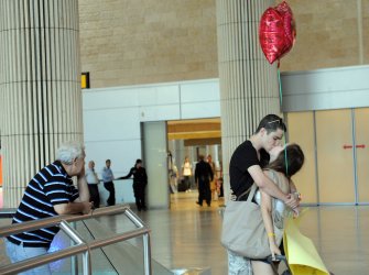 An Israeli couple kiss in Ben Gurion International Airport near Tel Aviv