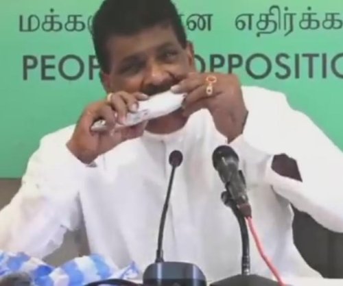 Sri Lankan lawmaker bites raw fish to bolster slumping sales