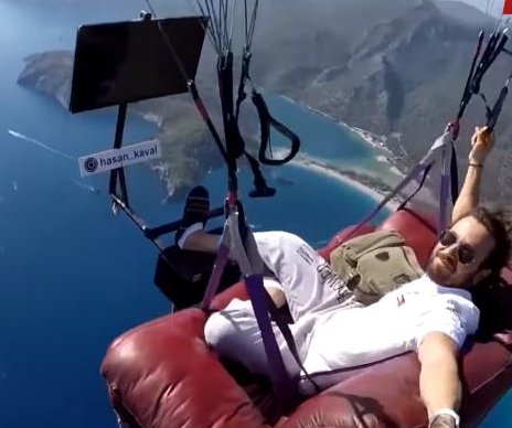 Turkish paragliding instructor takes couch, TV into the sky
