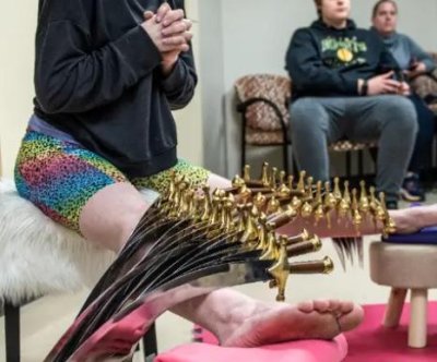 Look: Minnesota woman balances 30 swords on her body in one minute - UPI.com