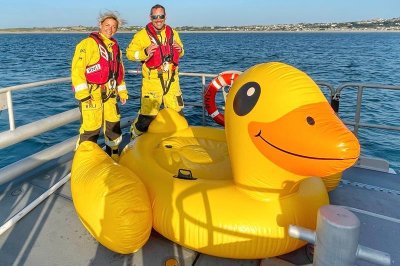 Three men swept out to sea on giant inflatable duck