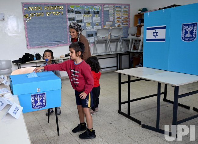 An Israeli Boys Cast His Motherâ€™s Ballot In A Polling Station In Har Homa Settlement