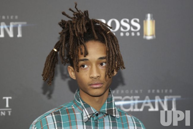 Jaden Smith holds a drink at the premiere of Allegiant