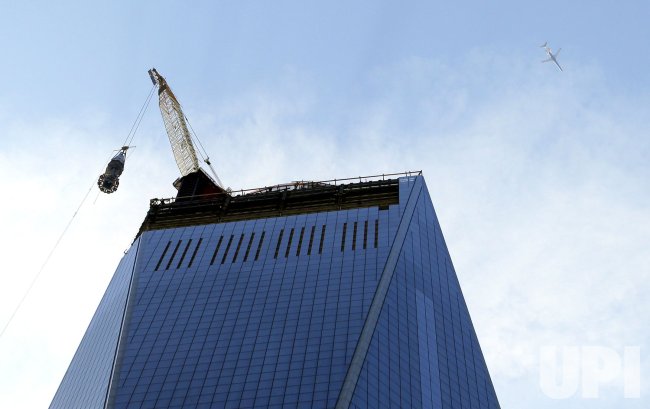 Final piece of spire raised to top of One World Trade Center