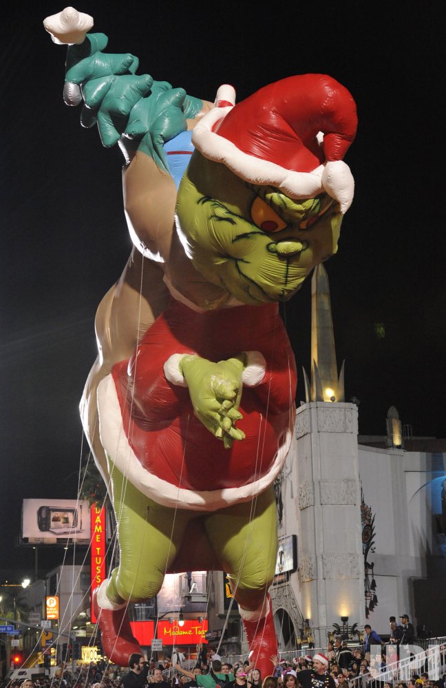 A balloon likeness of Dr Suess' "Grinch" flies in the Hollywood Christmas Parade in Los Angeles