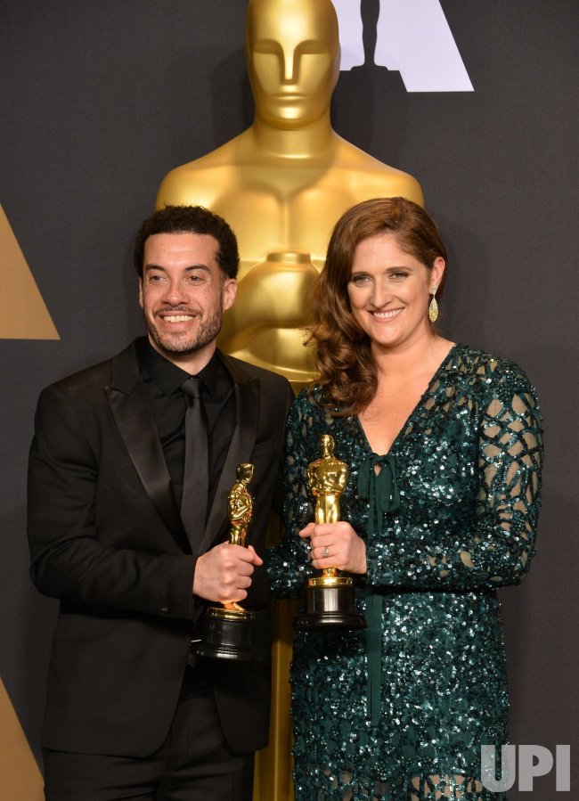 Ezra Edelman and Caroline Waterlow, appear backstage with their awards at the 89th annual Academy Awards in Hollywood