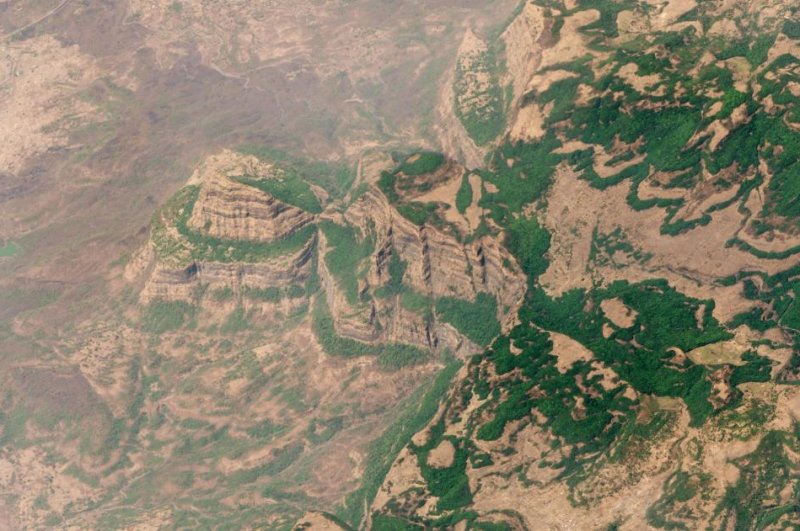 During the late Permian period, India's Deccan Traps erupted. New research suggests the outgassing that occurred as a part of the volcanic activity happened well before the extinction event that killed the dinosaurs. Photo by Planet Labs/<a href="https://commons.wikimedia.org/wiki/File:Deccan_Traps_Maharashtra_India_22Mar2018_SkySat.jpg">Wikimedia Commons</a><br>