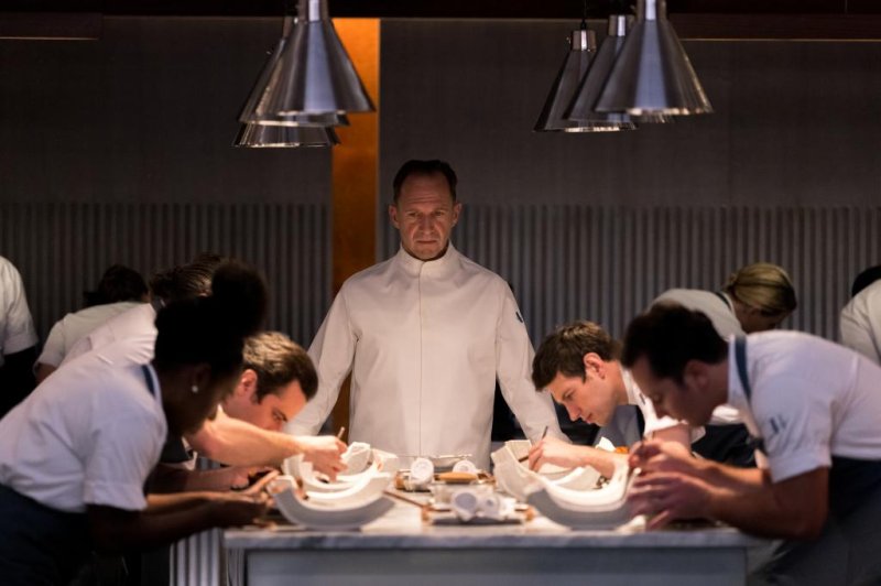 Chef Slowik (Ralph Fiennes, center) presides over his kitchen in "The Menu." Photo courtesy of Searchlight Pictures